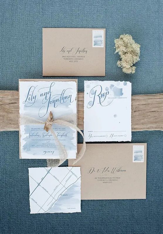 ethereal blue watercolor wedding invies with a raw edge and kraft paper envelopes are great for a coastal or beach wedding