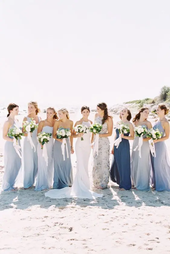 mismatching blue maxi bridesmaid dresses with various necklines look breezy, romantic and lovely at the beach
