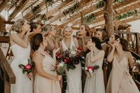 mismatching blush, off-white, white and taupe maxi bridesmaid dresses for a relaxed beach tropical wedding