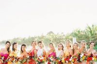 mismatching coral, blush, yellow and hot pink maxi bridesmaid dresses with various slits are bold and cool