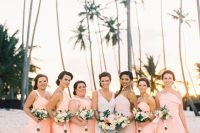 mismatching peachy pink maxi bridesmaid dresses for a bright and cheerful tropical beach wedding