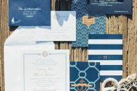 nautical invitations with stripes and just navy envelopes, sea-inspired prints, touches of gold are great for a beach wedding