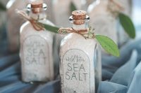 sea salt in bottles with leaves and tags are amazing beach wedding favors and they won’t break the bank