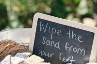 some brushes to wipe off sand from the feet are a simple and useful wedding favor idea