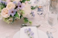 some lilac-colored blooms in the centerpiece and on each palce setting to make it chic and stylish