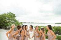 taupe maxi bridesmaid dresses with thick straps and deep V-necklines and pleated skirts for a beach wedding