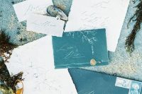 teal and blue wedding invitation suite with a raw edge and elegant seals, with some drawings and calligraphy is amazing for a beach or coastal wedding
