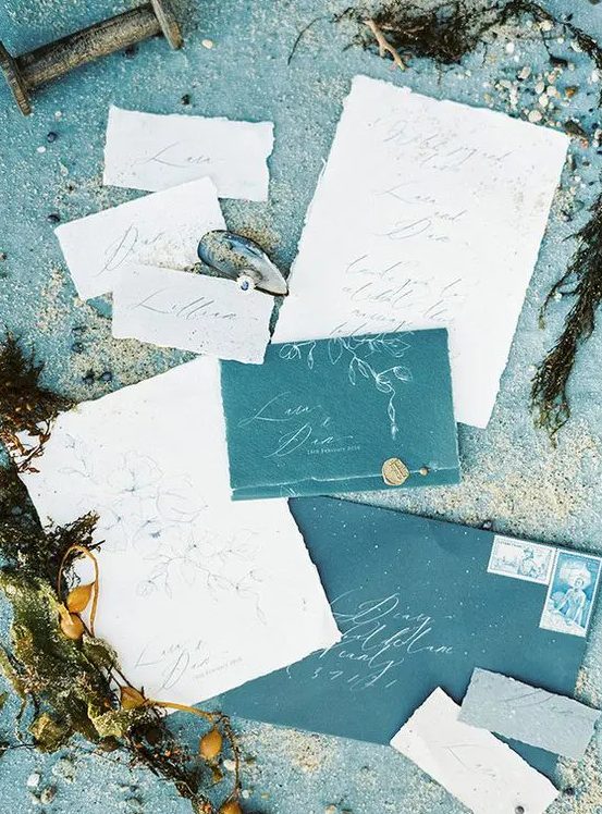 teal and blue wedding invitation suite with a raw edge and elegant seals, with some drawings and calligraphy is amazing for a beach or coastal wedding