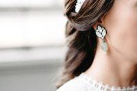 a beautiful pearl headband and statement rhinestone earrings for accessorizing a modern boho bridal look