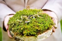 a birch slice with moss on top is a very natural idea for a woodland or forest wedding