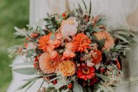a bold orange wedding bouquet with touches of blush and red blooms, lots of greenery and some berrries will fit a summer or fall wedding