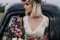 a colorful floral crown with lilac, red and orange and blush blooms and some greenery for a spring or summer boho wedding