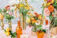 a colorful summer wedding tablescape with a bold printed runner, bold pink, orange and yellow blooms and greenery and colorful plates