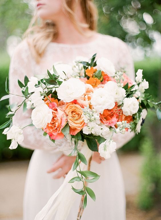 a cool summer wedding bouquet of white, pink and orange blooms and some greenery is amazing for summer