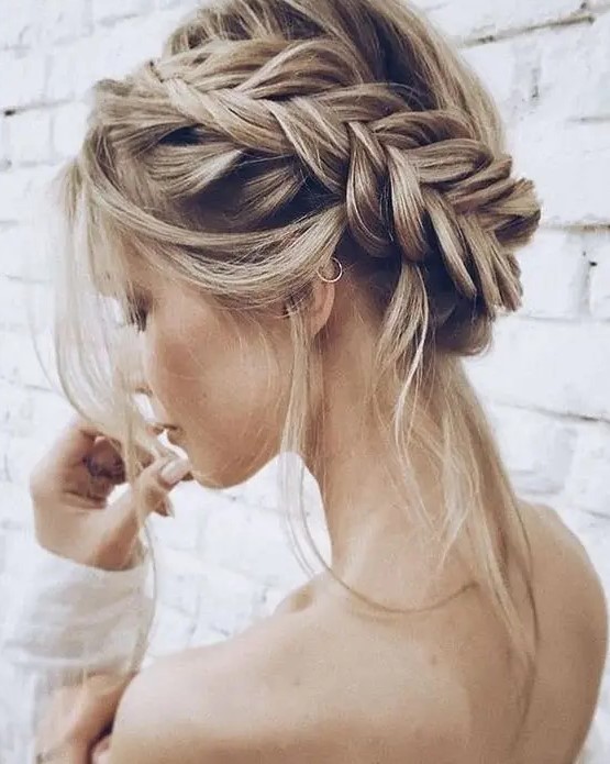 a dimension fishtail halo braided updo with some locks down for a boho chic look is a lovely idea for a boho bride