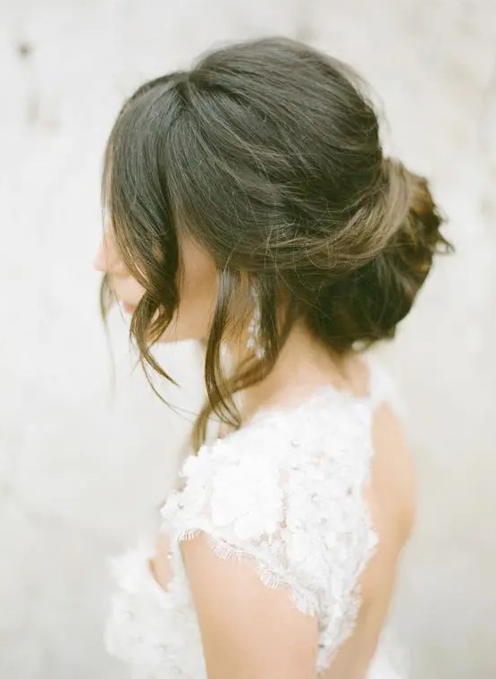 a dimensional low bun and some waves down for a timelessly elegant look, with a slight vintage feel