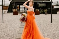 a fantastic orange A-line wedding dress with a corset, spaghetti straps and a train is amazing for a bright summer wedding