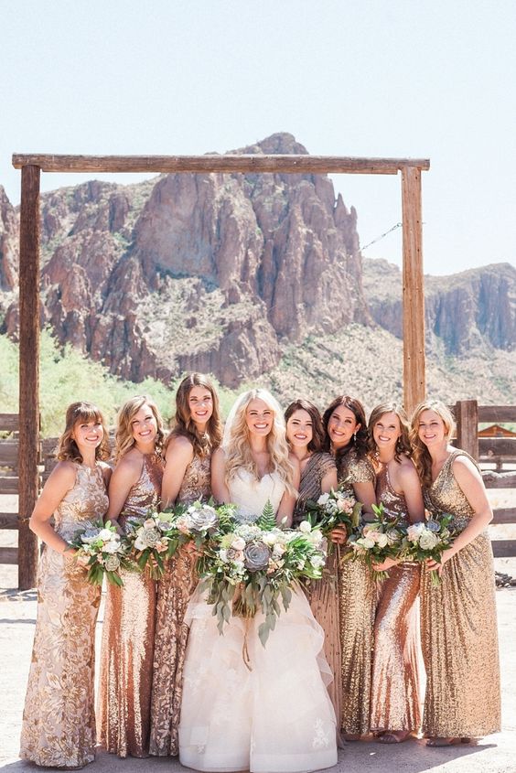a gorgeous bridal party wearing rose gold and gold maxi bridesmaid dresses of various designs for a glam and shiny wedding