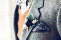 a grey tweed suit, a tan waistcoat, a neutrla button down, a printed bow tie and handkerchief
