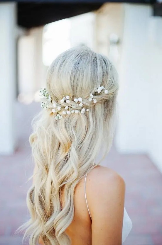 a half up with a twist and baby's breath in it, some waves for a romantic look at a boho beach wedding or some other boho wedding
