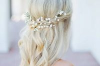 a half updo with a halo with baby’s breath and waves down for a romantic and classic look