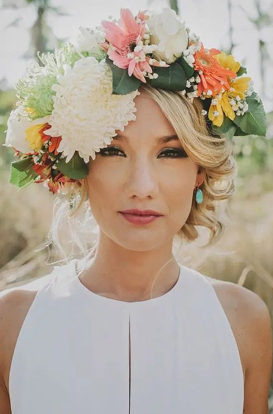 a large summer floral crown with neutral, pink, yellow and orange blooms plus greenery is a gorgeous idea for a spring or summer bride