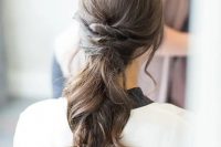 a low ponytail with twists and waves for a modern beach bride, it’s a stylish solution for many weddings, and it can be worn with long or medium-length hair