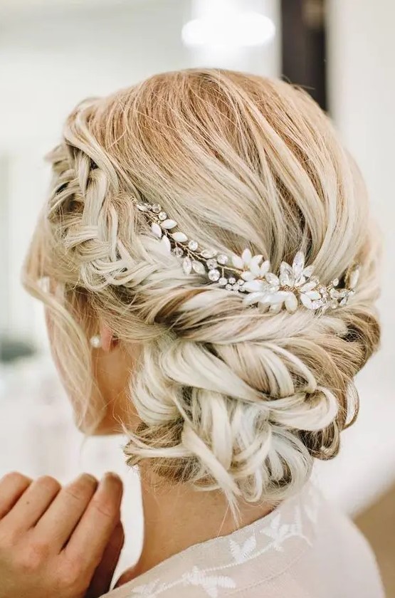 a low updo with a volume on top, a braided halo and a low bun plus a pearl and rhinestone headpiece
