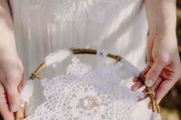 a macrame attached to branches is a cool idea for a boho wedding, attach your rings on top