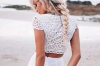 a messy braid with some locks down and much volume looks amazing with such beach bleached hair and it ideal for a boho beaсh bride