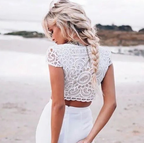 a messy braid with some locks down and much volume looks amazing with such beach bleached hair and it ideal for a boho beaсh bride