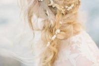 a messy layered braid with twists and a pearl hair vine for a coastal or beach bride with a laid-back touch