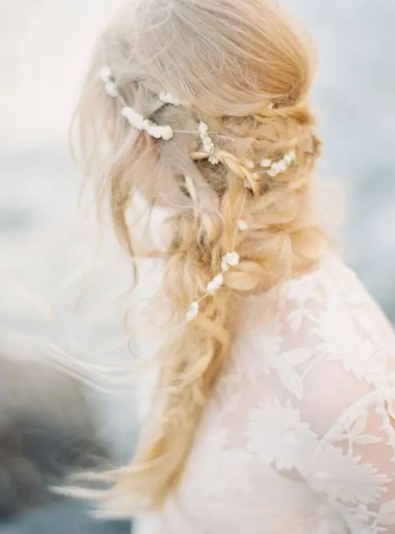 a messy layered braid with twists and a pearl hair vine for a coastal or beach bride with a laid-back touch