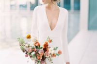 a minimalist plain sheath wedding dress with long sleeves and a plunging neckline for a sexy touch