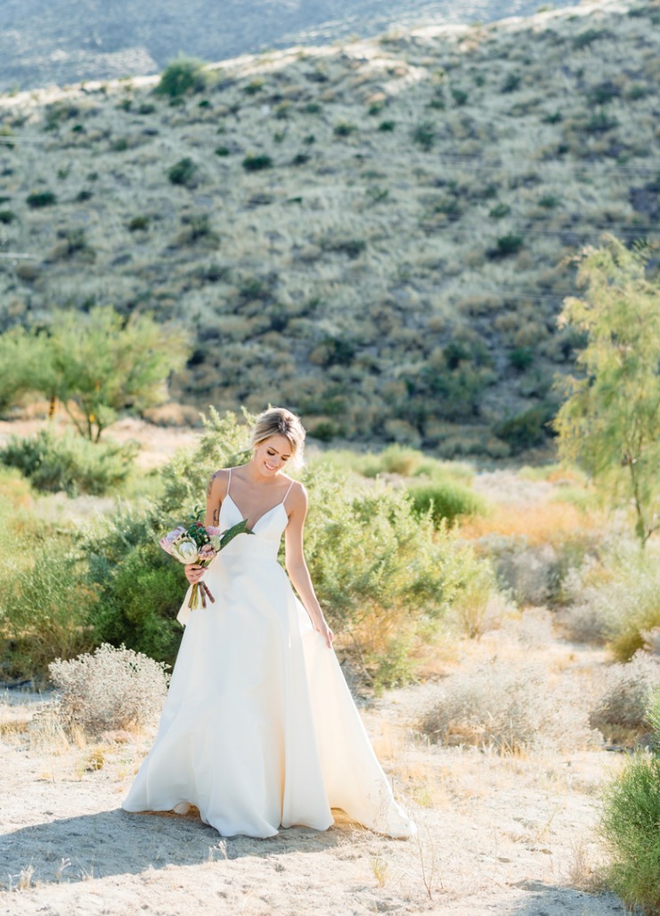 a minimalist wedding ballgown with a plunging neckline, spaghetti straps and a train for a modern romantic bride