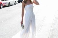 a modern strapless fitting jumpsuit and an overskirt, metallic heels and a striped clutch