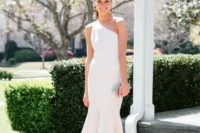 a one shoulder sheath white dress with a ruffled asymmetrical skirt, statement earrings and shoes