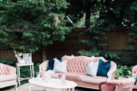a pink vintage lounge with refined furniture, blue pillows, coffee tables and a neutral rug will fit a summer wedding