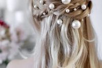 a romantic half updo with a braided halo and pearl pins of various sizes – smaller and larger ones