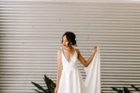 a sexy wedding ballgown with a plunging neckline, spaghetti straps and a draped skirt plus a train