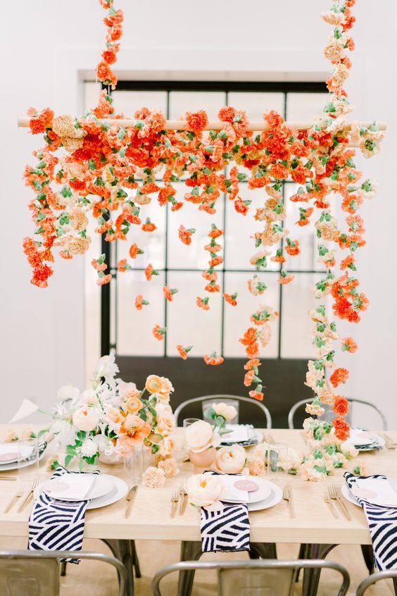 a super bold modern floral chandelier made of orange and peachy carnations is a gorgeous color statement