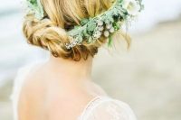 a twisted updo with some locks down and a greenery crown can be worn with medium or long hair, and a greenery crown adds interest to the look