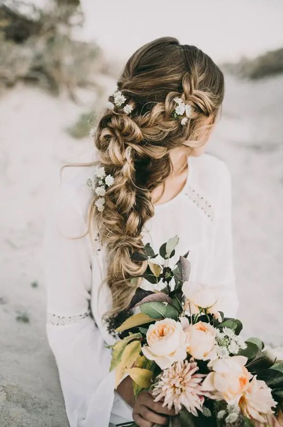 a very dimensional and textural braid made of two side ones with fresh flowers is always a good idea for a relaxed or boho bridal look