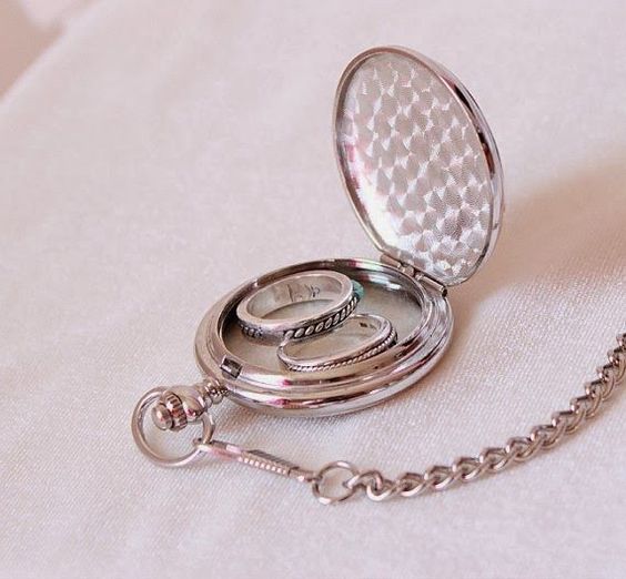 a vintage pocket watch updated for carrying your wedding rings is a stylish idea for a vintage-inspired wedding