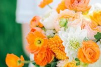 a vivacious and bright wedding bouquet of yellow, orange, white and blush blooms, berries and greenery for summer