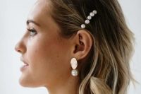 a wavy short bob with some pearl pins and matching gold and pearl earrings for a modern beach bride