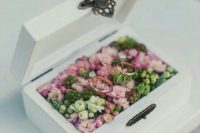 a white box filled with greenery and fresh pink blooms looks refined and is ideal for a garden wedding