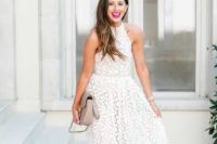 a white lace A-line midi dress with a halter neckline, nude shoes and a neutral bag