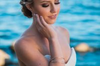 a wrapped tightly braided halo with a low braided bun is a very picture-perfect idea for a boho beach bride or just a boho bride