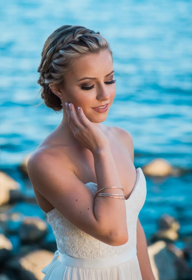 a wrapped tightly braided halo with a low braided bun is a very picture-perfect idea for a boho beach bride or just a boho bride